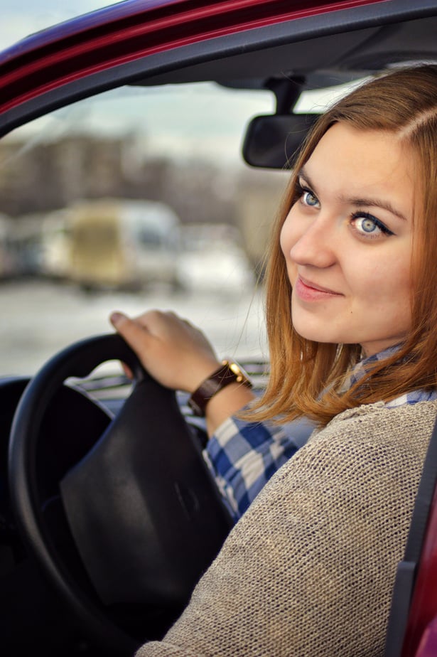 Woman in Gray and Black Long Sleeve Shirt Driving Car